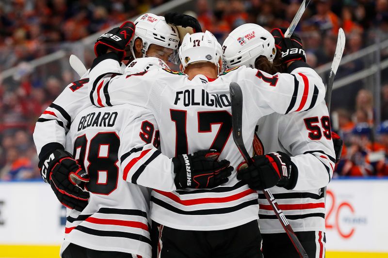 Oct 12, 2024; Edmonton, Alberta, CAN; The Chicago Blackhawks celebrate a goal scored by  defensemen Seth Jones (4) during the second period against the Edmonton Oilers at Rogers Place. Mandatory Credit: Perry Nelson-Imagn Images