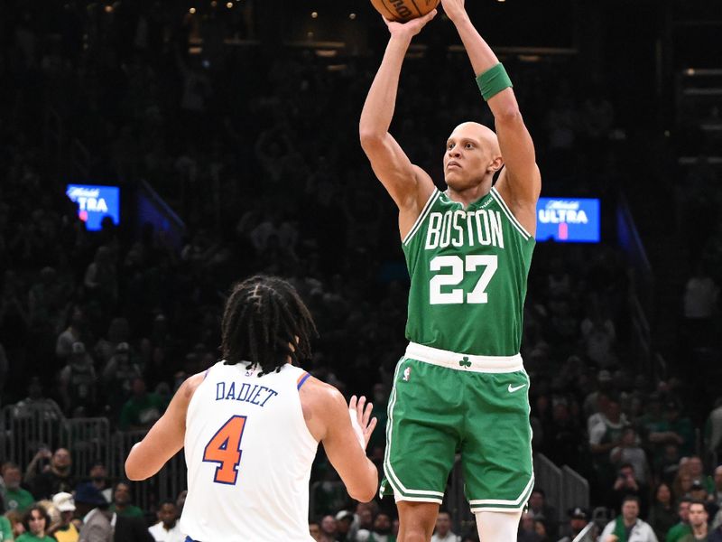 BOSTON, MASSACHUSETTS - OCTOBER 22: Jordan Walsh #27 of the Boston Celtics takes a shot over Pacome Dadiet #4 of the New York Knicks during the fourth quarter at TD Garden on October 22, 2024 in Boston, Massachusetts. (Photo by Brian Fluharty/Getty Images)