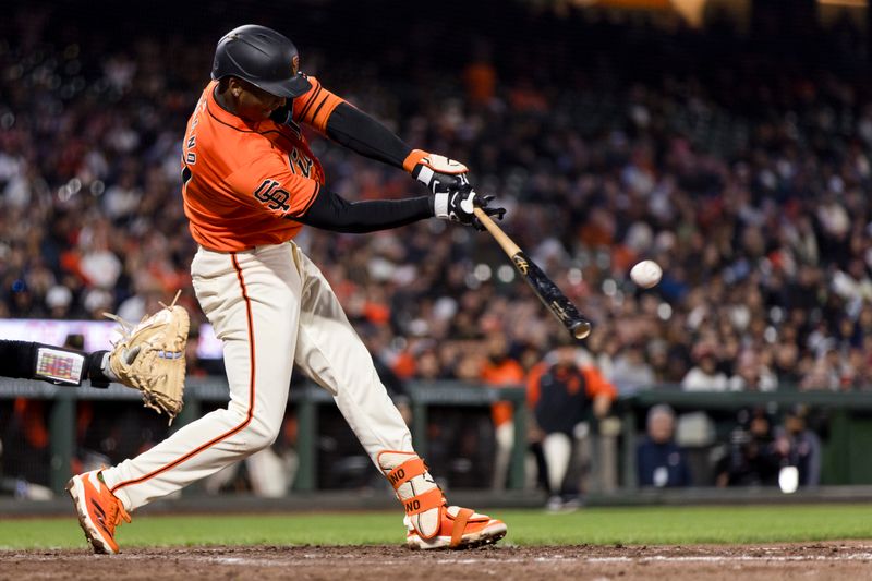 May 17, 2024; San Francisco, California, USA; San Francisco Giants shortstop Marco Luciano (37) hits an RBI single against the Colorado Rockies during the seventh inning at Oracle Park. Mandatory Credit: John Hefti-USA TODAY Sports