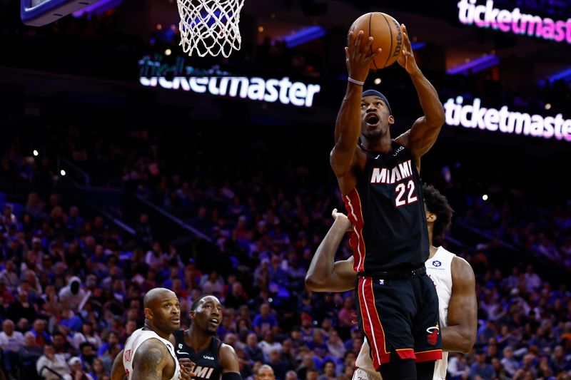 PHILADELPHIA, PA - APRIL 06: Jimmy Butler #22 of the Miami Heat puts up a shot against Joel Embiid #21 of the Philadelphia 76ers in the second half at Wells Fargo Center on April 6, 2023 in Philadelphia, Pennsylvania. The Heat defeated the 76ers 129-101. NOTE TO USER: User expressly acknowledges and agrees that, by downloading and or using this photograph, User is consenting to the terms and conditions of the Getty Images License Agreement. (Photo by Rich Schultz/Getty Images)