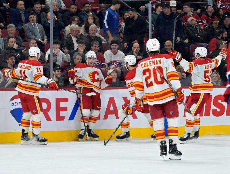 Nov 5, 2024; Montreal, Quebec, CAN; Calgary Flames forward Matt Coronato (27) celebrates with teammates after scoring a goal against the Montreal Canadiens during the third period at the Bell Centre. Mandatory Credit: Eric Bolte-Imagn Images