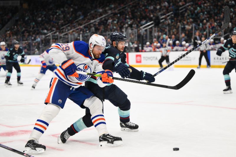 Oct 2, 2024; Seattle, Washington, USA; Edmonton Oilers center Leon Draisaitl (29) and Seattle Kraken right wing Oliver Bjorkstrand (22) fight for the loose puck during the second period at Climate Pledge Arena. Mandatory Credit: Steven Bisig-Imagn Images