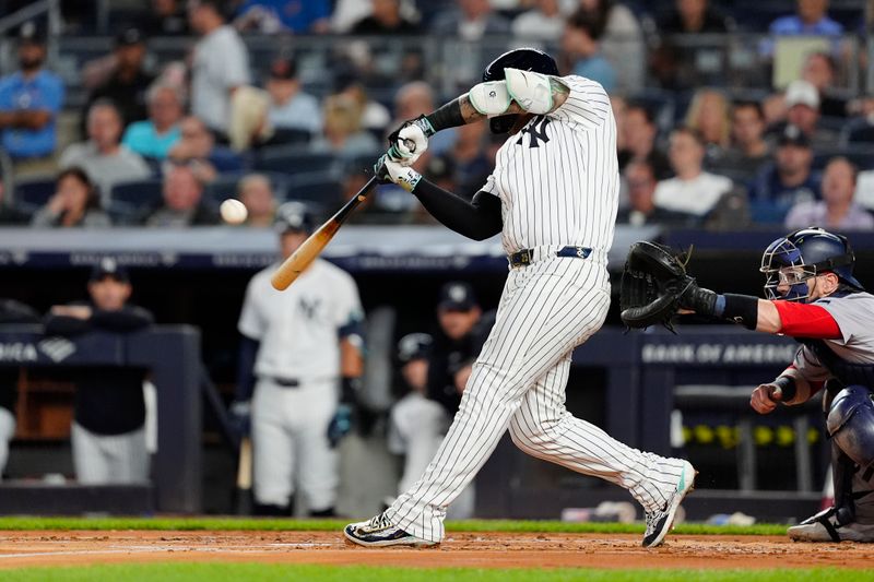 Sep 12, 2024; Bronx, New York, USA; New York Yankees second baseman Gleyber Torres (25) hits a home run against the Boston Red Sox during the first inning at Yankee Stadium. Mandatory Credit: Gregory Fisher-Imagn Images