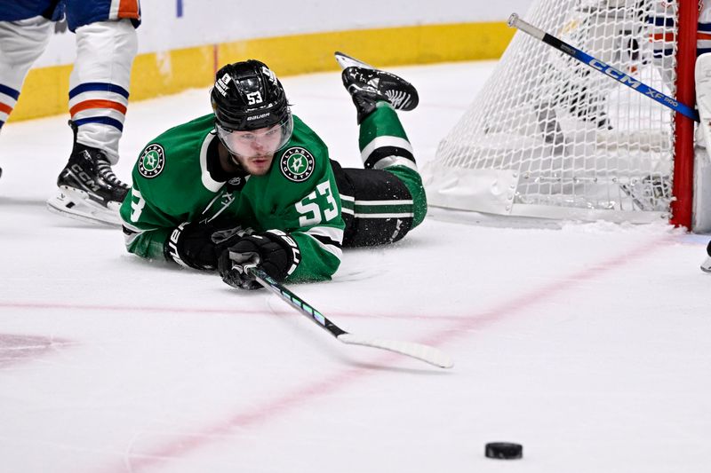 May 23, 2025; Dallas, Texas, USA; Dallas Stars center Wyatt Johnston (53) falls to the ice against the Edmonton Oilers in the second period for game two of the Western Conference Final of the 2025 Stanley Cup Playoffs at American Airlines Center. Mandatory Credit: Jerome Miron-Imagn Images