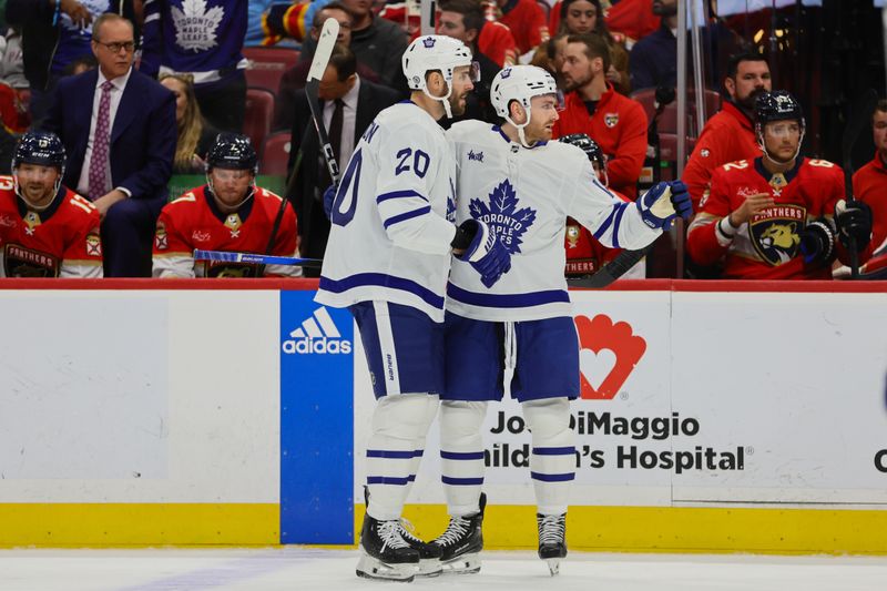 Apr 16, 2024; Sunrise, Florida, USA; Toronto Maple Leafs center Noah Gregor (18) celebrates with defenseman Joel Edmundson (20) after scoring against the Florida Panthers during the first period at Amerant Bank Arena. Mandatory Credit: Sam Navarro-USA TODAY Sports