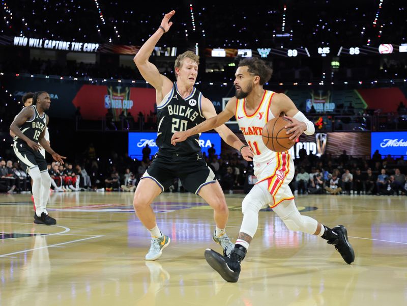 LAS VEGAS, NEVADA - DECEMBER 14: Trae Young #11 of the Atlanta Hawks drives against AJ Green #20 of the Milwaukee Bucks in the second half of a semifinal game of the Emirates NBA Cup at T-Mobile Arena on December 14, 2024 in Las Vegas, Nevada. The Bucks defeated the Hawks 110-102. NOTE TO USER: User expressly acknowledges and agrees that, by downloading and or using this photograph, User is consenting to the terms and conditions of the Getty Images License Agreement. (Photo by Ethan Miller/Getty Images)