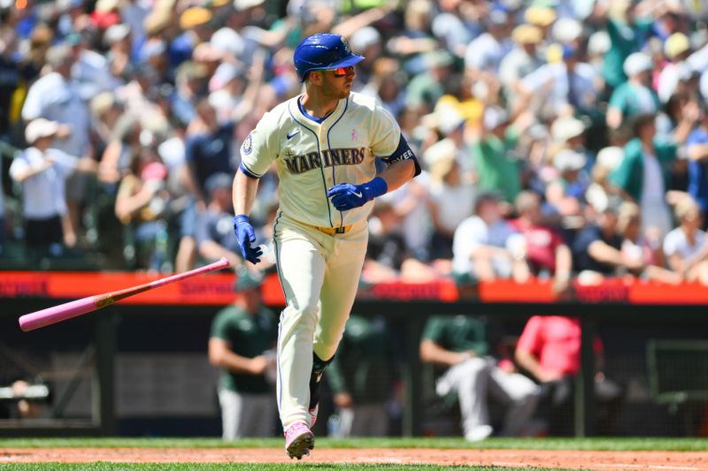 May 12, 2024; Seattle, Washington, USA; Seattle Mariners designated hitter Mitch Garver (18) runs towards first base after hitting a 2-run home run against the Oakland Athletics during the fifth inning at T-Mobile Park. Mandatory Credit: Steven Bisig-USA TODAY Sports