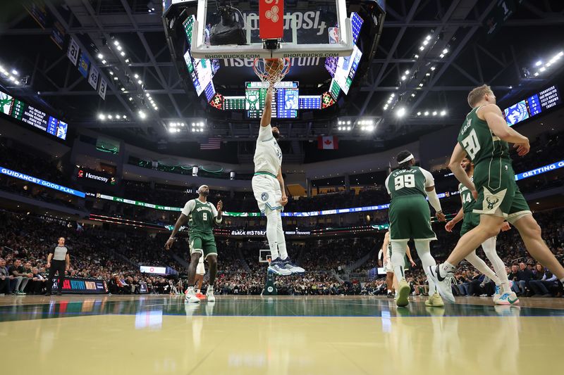 MILWAUKEE, WISCONSIN - FEBRUARY 08: Karl-Anthony Towns #32 of the Minnesota Timberwolves dunks against the Milwaukee Bucks during a game at Fiserv Forum on February 08, 2024 in Milwaukee, Wisconsin. NOTE TO USER: User expressly acknowledges and agrees that, by downloading and or using this photograph, User is consenting to the terms and conditions of the Getty Images License Agreement. (Photo by Stacy Revere/Getty Images)