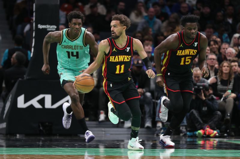 CHARLOTTE, NC - NOVEMBER 30: Trae Young #11 of the Atlanta Hawks dribbles the ball during the game against the Charlotte Hornets on November 30, 2024 at Spectrum Center in Charlotte, North Carolina. NOTE TO USER: User expressly acknowledges and agrees that, by downloading and or using this photograph, User is consenting to the terms and conditions of the Getty Images License Agreement. Mandatory Copyright Notice: Copyright 2024 NBAE (Photo by Brock Williams-Smith/NBAE via Getty Images)