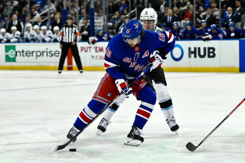 Oct 12, 2024; New York, New York, USA; New York Rangers left wing Artemi Panarin (10) skates with the puck against Utah Hockey Club center Nick Schmaltz (8) during the second period at Madison Square Garden. Mandatory Credit: John Jones-Imagn Images