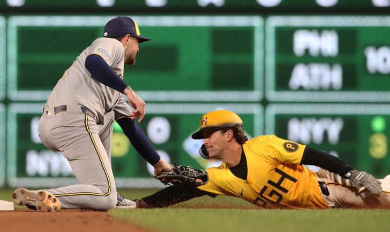 May 23, 2025; Pittsburgh, Pennsylvania, USA;  Milwaukee Brewers second baseman Brice Turang (2) tags Pittsburgh Pirates second baseman Adam Frazier (26) out at second base on a steal attempt to end the eighth inning at PNC Park. Mandatory Credit: Charles LeClaire-Imagn Images