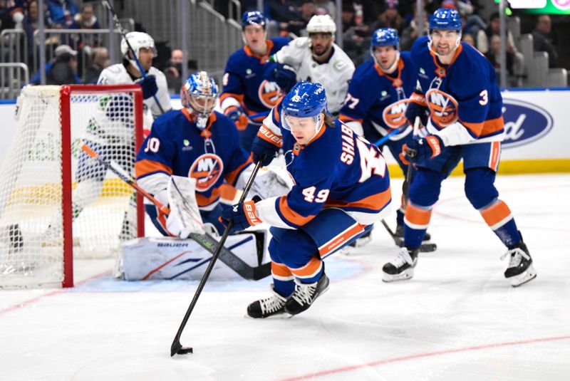 Dec 19, 2025; Elmont, New York, USA; New York Islanders right wing Max Shabanov (49) skates with the puck against the Vancouver Canucks during the first period at UBS Arena. Mandatory Credit: John Jones-Imagn Images