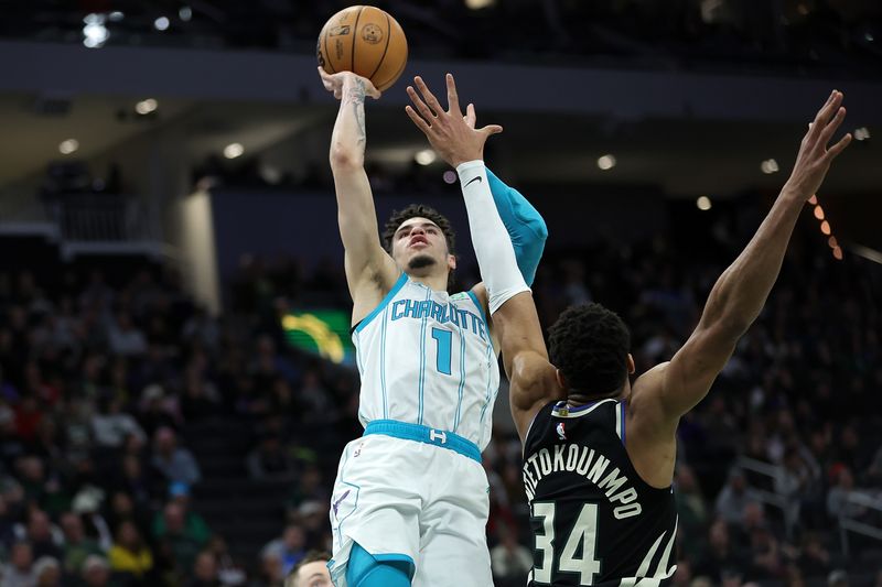 MILWAUKEE, WISCONSIN - JANUARY 31: LaMelo Ball #1 of the Charlotte Hornets is defended by Giannis Antetokounmpo #34 of the Milwaukee Bucks during the second half of a game at Fiserv Forum on January 31, 2023 in Milwaukee, Wisconsin. NOTE TO USER: User expressly acknowledges and agrees that, by downloading and or using this photograph, User is consenting to the terms and conditions of the Getty Images License Agreement. (Photo by Stacy Revere/Getty Images)