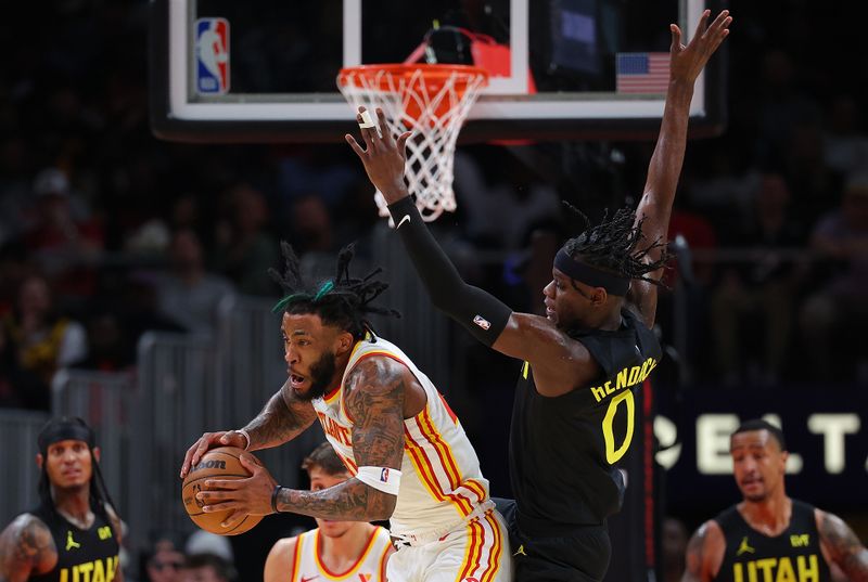 ATLANTA, GEORGIA - FEBRUARY 27:  Saddiq Bey #41 of the Atlanta Hawks grabs a rebound against Taylor Hendricks #0 of the Utah Jazz during the second quarter at State Farm Arena on February 27, 2024 in Atlanta, Georgia.  NOTE TO USER: User expressly acknowledges and agrees that, by downloading and/or using this photograph, user is consenting to the terms and conditions of the Getty Images License Agreement.  (Photo by Kevin C. Cox/Getty Images)