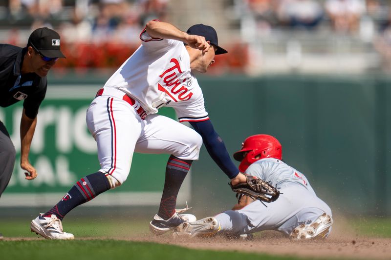 Sep 15, 2024; Minneapolis, Minnesota, USA; Cincinnati Reds third baseman Santiago Espinal (4) steals and slides into second base before Minnesota Twins shortstop Brooks Lee (72) can make a tag in the sixth inning at Target Field. Mandatory Credit: Jesse Johnson-Imagn Images