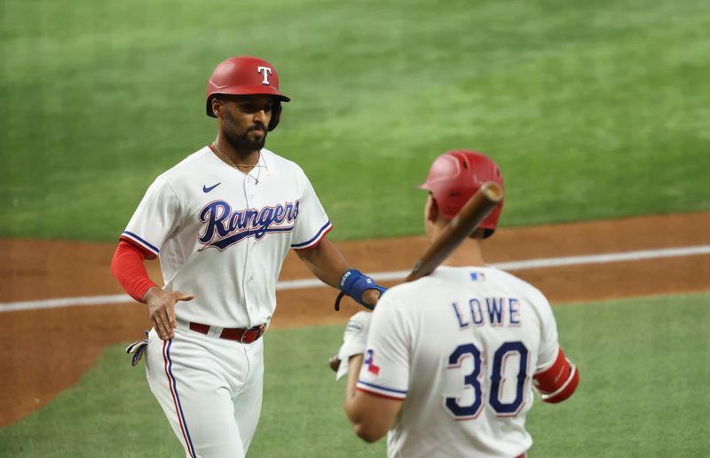 Jun 28, 2023; Arlington, Texas, USA;  Texas Rangers second baseman Marcus Semien (2) celebrates with Texas Rangers first baseman Nathaniel Lowe (30) after scoring during the first inning against the Detroit Tigers at Globe Life Field. Mandatory Credit: Kevin Jairaj-USA TODAY Sports