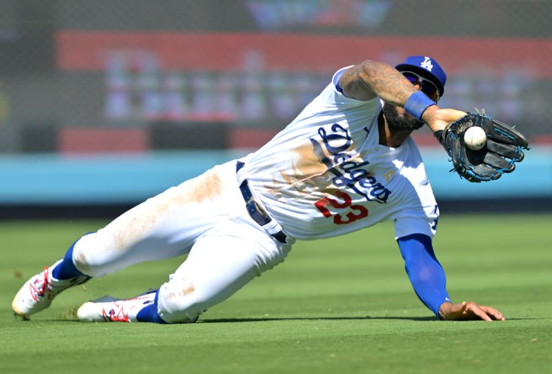 Sep 3, 2023; Los Angeles, California, USA;  Los Angeles Dodgers right fielder Jason Heyward (23) makes a sliding catch off a ball hit by Atlanta Braves second baseman Ozzie Albies (1) in the sixth inning at Dodger Stadium. Mandatory Credit: Jayne Kamin-Oncea-USA TODAY Sports