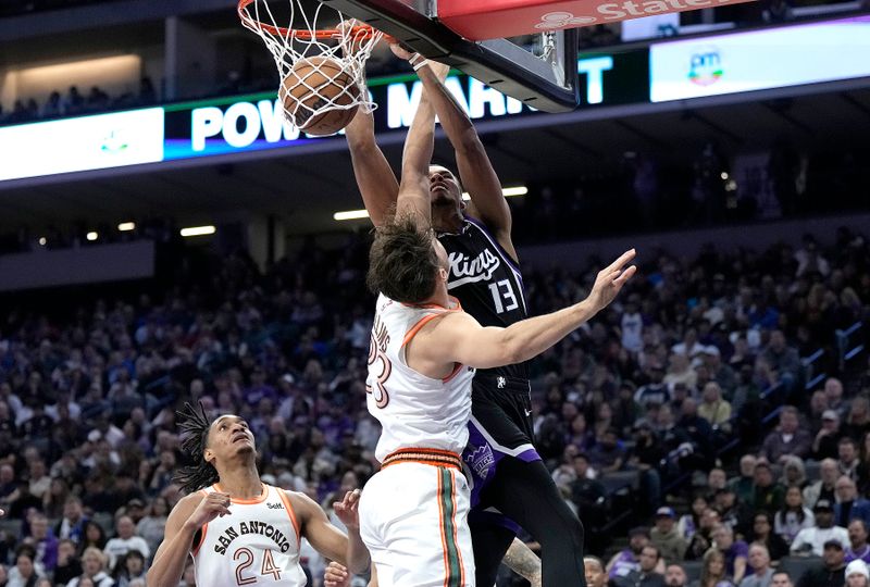 SACRAMENTO, CALIFORNIA - FEBRUARY 22: Keegan Murray #13 of the Sacramento Kings slam dunks over Zach Collins #23 of the San Antonio Spurs in the fourth quarter at Golden 1 Center on February 22, 2024 in Sacramento, California. NOTE TO USER: User expressly acknowledges and agrees that, by downloading and or using this photograph, User is consenting to the terms and conditions of the Getty Images License Agreement. (Photo by Thearon W. Henderson/Getty Images)