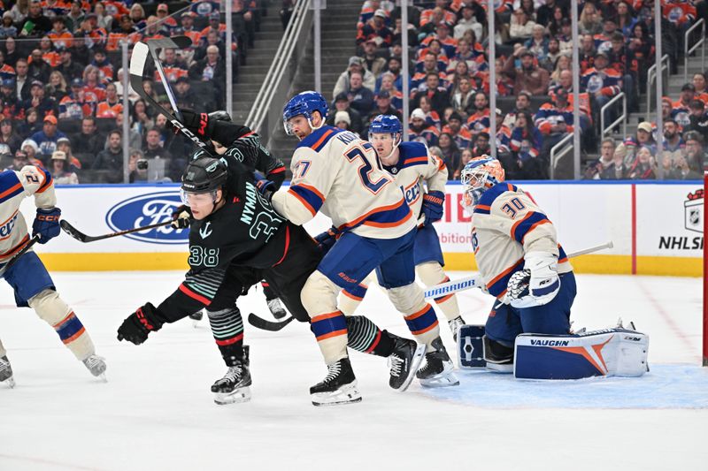 Dec 4, 2025; Edmonton, Alberta, CAN;  Seattle Kraken right winger Jari Nyman (38) battles with Edmonton Oilers defenseman Brett Kulak (27) in front of Oilers goalie Calvin Pickard (30) during the second period at Rogers Place. Mandatory Credit: Walter Tychnowicz-Imagn Images