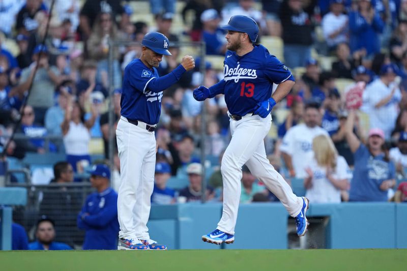 Mar 23, 2025; Los Angeles, California, USA; Los Angeles Dodgers third base Max Muncy (13) is congratulated by Los Angeles Dodgers third base coach/outfield coach Dino Ebel (91) after hitting a home run in the fifth inning against the Los Angeles Angels  at Dodger Stadium. Mandatory Credit: Kirby Lee-Imagn Images