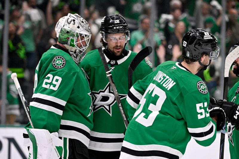 May 11, 2025; Dallas, Texas, USA; Dallas Stars goaltender Jake Oettinger (29) and defenseman Alexander Petrovic (28) celebrate the Stars win over the Winnipeg Jets in game three of the second round of the 2025 Stanley Cup Playoffs at American Airlines Center. Mandatory Credit: Jerome Miron-Imagn Images