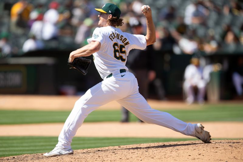 Jul 20, 2024; Oakland, California, USA; Oakland Athletics pitcher Tyler Ferguson (65) delivers a pitch against the Los Angeles Angels during the ninth inning at Oakland-Alameda County Coliseum. Mandatory Credit: D. Ross Cameron-USA TODAY Sports