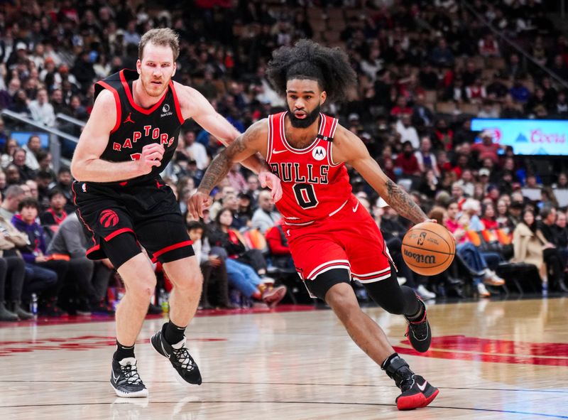 TORONTO, ON - JANUARY 31: Coby White #0 of the Chicago Bulls drives against Jakob Poeltl #19 of the Toronto Raptors during the second half of their basketball game at the Scotiabank Arena on January 31, 2025 in Toronto, Ontario, Canada. NOTE TO USER: User expressly acknowledges and agrees that, by downloading and/or using this Photograph, user is consenting to the terms and conditions of the Getty Images License Agreement. (Photo by Mark Blinch/Getty Images)