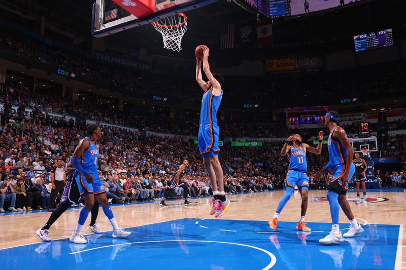 OKLAHOMA CITY, OK - APRIL 9: Chet Holmgren #7 of the Oklahoma City Thunder grabs a rebound during the game against the Sacramento Kings on April 9, 2024 at Paycom Arena in Oklahoma City, Oklahoma. NOTE TO USER: User expressly acknowledges and agrees that, by downloading and or using this photograph, User is consenting to the terms and conditions of the Getty Images License Agreement. Mandatory Copyright Notice: Copyright 2024 NBAE (Photo by Zach Beeker/NBAE via Getty Images)