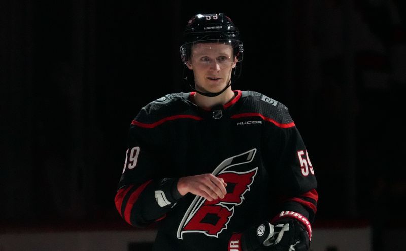 Apr 5, 2024; Raleigh, North Carolina, USA; Carolina Hurricanes center Jake Guentzel (59) celebrates after their victory against the Washington Capitals at PNC Arena. Mandatory Credit: James Guillory-USA TODAY Sports