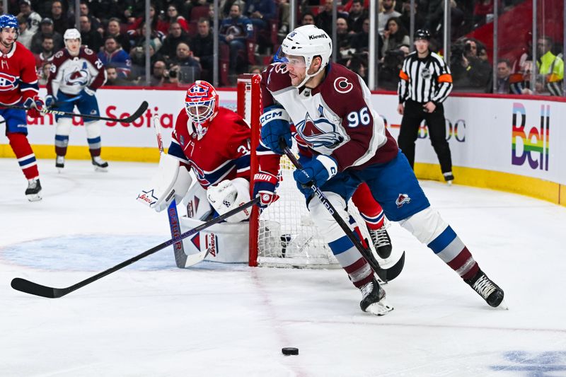 Jan 15, 2024; Montreal, Quebec, CAN; Colorado Avalanche right wing Mikko Rantanen (96) plays the puck near Montreal Canadiens goalie Jake Allen (34) during the second period at Bell Centre. Mandatory Credit: David Kirouac-USA TODAY Sports