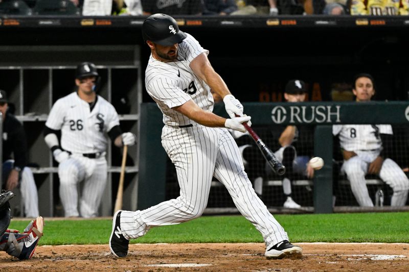 Jun 7, 2024; Chicago, Illinois, USA;  Chicago White Sox shortstop Paul DeJong (29) hits an RBI single against the Boston Red Sox during the fourth inning at Guaranteed Rate Field. Mandatory Credit: Matt Marton-USA TODAY Sports