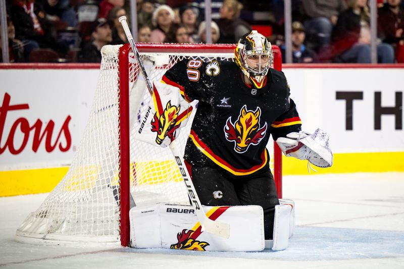 Nov 23, 2024; Calgary, Alberta, CAN; Calgary Flames goaltender Daniel Vladar (80) covers his net against the Minnesota Wild during the third period at Scotiabank Saddledome. Mandatory Credit: Brett Holmes-Imagn Images