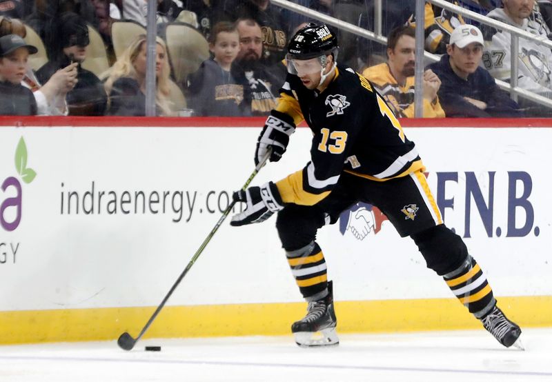 Mar 9, 2023; Pittsburgh, Pennsylvania, USA;  Pittsburgh Penguins center Nick Bonino (13) moves the puck against the New York Islanders during the third period at PPG Paints Arena. The Islanders won 4-3 in overtime. Mandatory Credit: Charles LeClaire-USA TODAY Sports