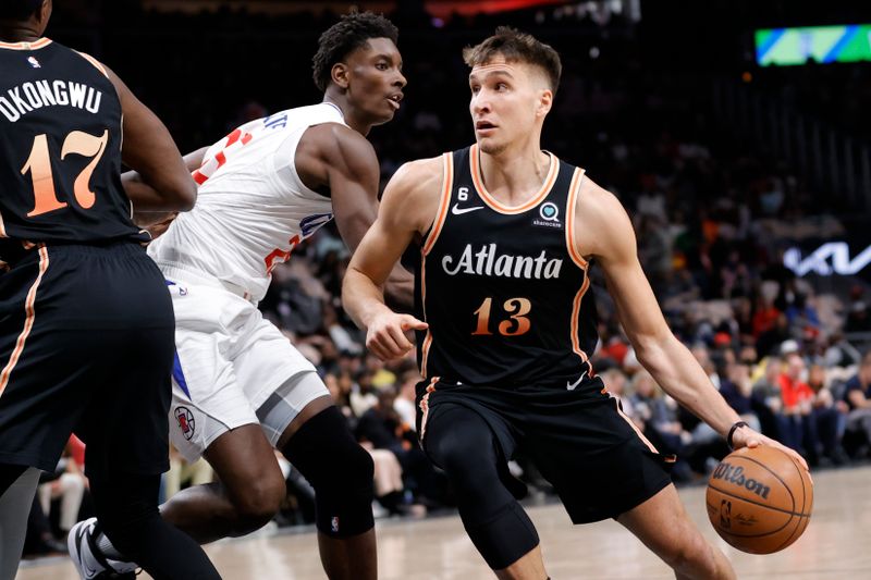 ATLANTA, GA - JANUARY 28: Bogdan Bogdanovic #13 of the Atlanta Hawks drives down court against Moussa Diabate #25 of the LA Clippers during the first half at State Farm Arena on January 28, 2023 in Atlanta, Georgia. NOTE TO USER: User expressly acknowledges and agrees that,  by downloading and or using this photograph,  User is consenting to the terms and conditions of the Getty Images License Agreement. (Photo by Alex Slitz/Getty Images)