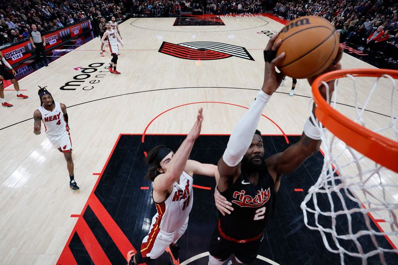 PORTLAND, OREGON - FEBRUARY 27: Deandre Ayton #2 of the Portland Trail Blazers dunks the ball past Jaime Jaquez Jr. #11 of the Miami Heat during the first half at Moda Center on February 27, 2024 in Portland, Oregon. NOTE TO USER: User expressly acknowledges and agrees that, by downloading and or using this photograph, User is consenting to the terms and conditions of the Getty Images License Agreement. (Photo by Soobum Im/Getty Images)