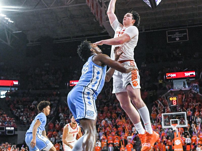 Jan 6, 2024; Clemson, South Carolina, USA; Clemson junior forward Ian Schieffelin (4) dunks near University of North Carolina forward Harrison Ingram (55) during the second half  at Littlejohn Coliseum. Mandatory Credit: Ken Ruinard-USA TODAY Sports