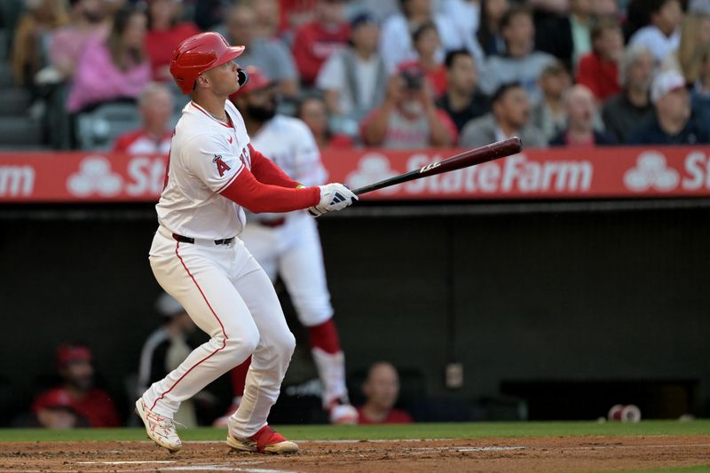 May 30, 2024; Anaheim, California, USA;  Los Angeles Angels catcher Logan O'Hoppe (14) hits a solo home run in the first inning against the New York Yankees at Angel Stadium. Mandatory Credit: Jayne Kamin-Oncea-USA TODAY Sports