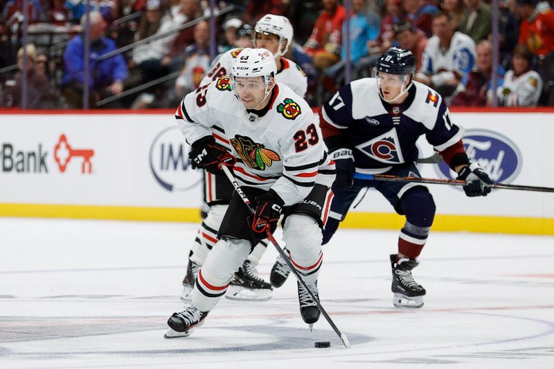 Oct 28, 2024; Denver, Colorado, USA; Chicago Blackhawks center Philipp Kurashev (23) controls the puck ahead of Chicago Blackhawks left wing Nick Foligno (17) in the third period at Ball Arena. Mandatory Credit: Isaiah J. Downing-Imagn Images