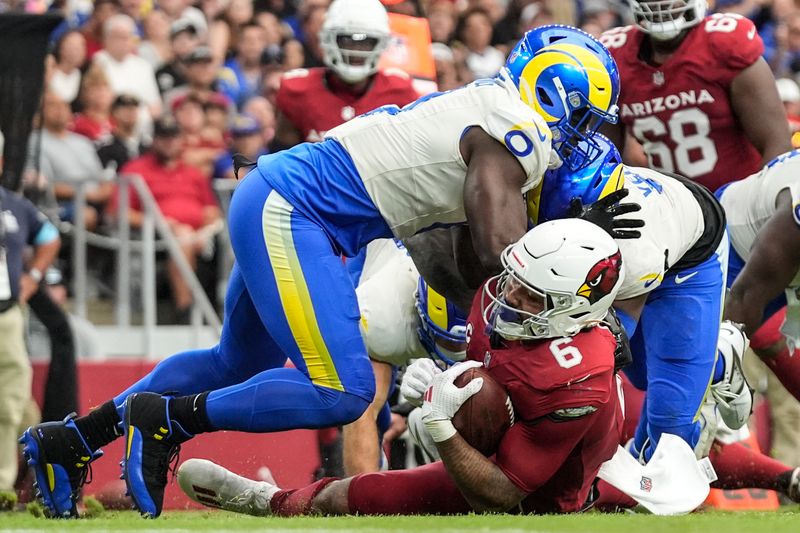 Arizona Cardinals running back James Conner (6) is hit by the Los Angeles Rams during the first half of an NFL football game, Sunday, Sept. 15, 2024, in Glendale, Ariz. (AP Photo/Ross D. Franklin)