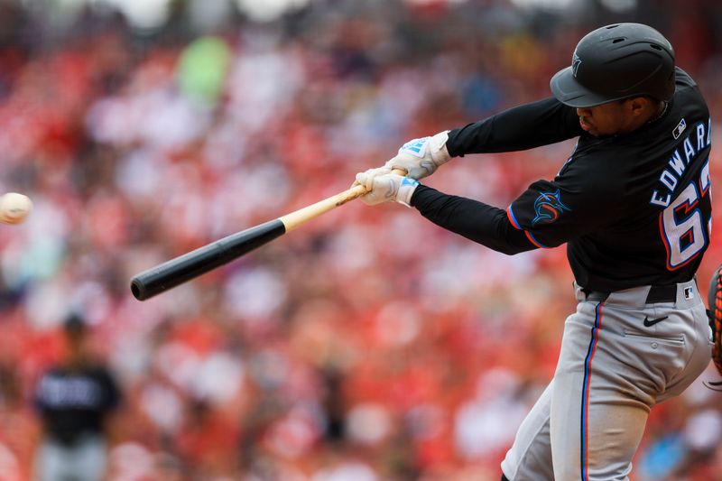 Jul 14, 2024; Cincinnati, Ohio, USA; Miami Marlins shortstop Xavier Edwards (63) hits a single in the sixth inning against the Cincinnati Reds at Great American Ball Park. Mandatory Credit: Katie Stratman-USA TODAY Sports