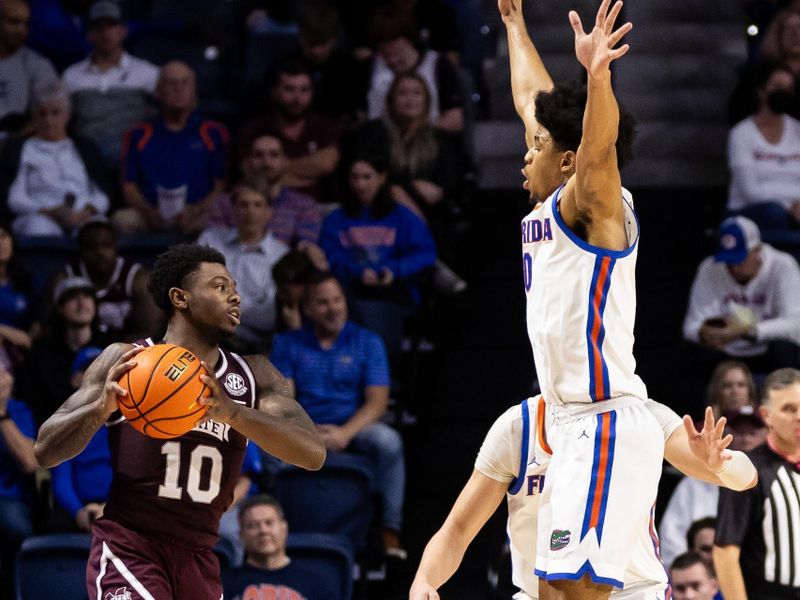 Jan 24, 2024; Gainesville, Florida, USA; Mississippi State Bulldogs guard Dashawn Davis (10) looks to pass around Florida Gators guard Zyon Pullin (0) and center Micah Handlogten (3) during the second half at Exactech Arena at the Stephen C. O'Connell Center. Mandatory Credit: Matt Pendleton-USA TODAY Sports