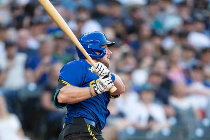 May 10, 2024; Seattle, Washington, USA; Seattle Mariners left fielder Luke Raley (20) hits a RBI-double during the fourth inning against the Oakland Athletics at T-Mobile Park. Mandatory Credit: Stephen Brashear-USA TODAY Sports