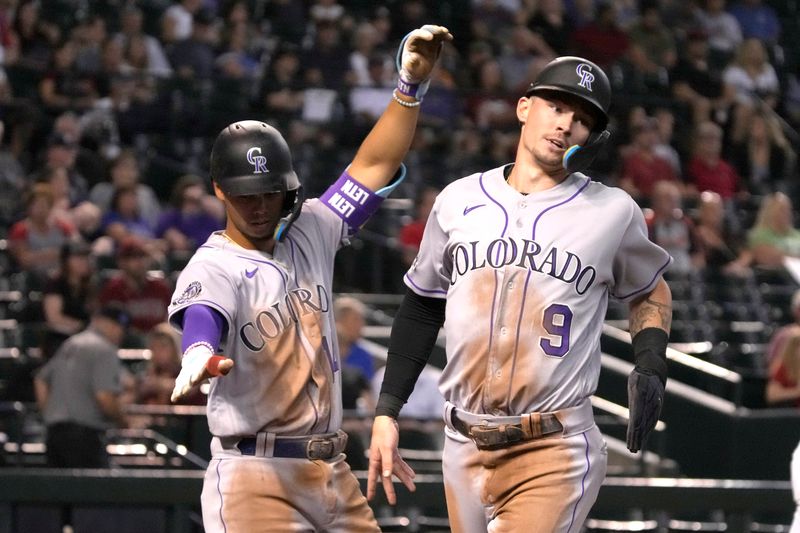 Sep 5, 2023; Phoenix, Arizona, USA; Colorado Rockies center fielder Brenton Doyle (9) celebrates with shortstop Ezequiel Tovar (14) after scoring a run against the Arizona Diamondbacks in the fourth inning at Chase Field. Mandatory Credit: Rick Scuteri-USA TODAY Sports