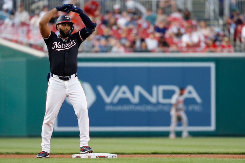Apr 24, 2025; Washington, District of Columbia, USA; Washington Nationals third base Amed Rosario (13) gestures to his dugout after hitting as double against the Baltimore Orioles during the second inning at Nationals Park. Mandatory Credit: Geoff Burke-Imagn Images