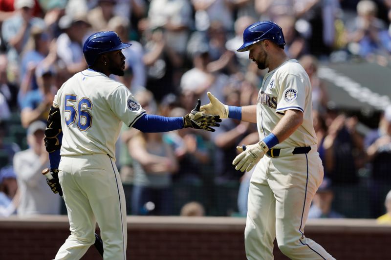 Jun 1, 2025; Seattle, Washington, USA; Seattle Mariners catcher Cal Raleigh (29), right, is greeted by Seattle Mariners Left fielder Randy Arozarena (56) on a solo home run against the Minnesota Twins during the seventh inning at T-Mobile Park. Mandatory Credit: John Froschauer-Imagn Images
