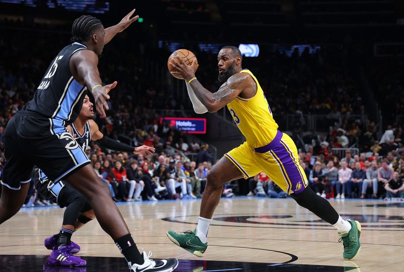 ATLANTA, GEORGIA - JANUARY 30:  LeBron James #23 of the Los Angeles Lakers drives against Trae Young #11 and Clint Capela #15 of the Atlanta Hawks during the second quarter at State Farm Arena on January 30, 2024 in Atlanta, Georgia.  NOTE TO USER: User expressly acknowledges and agrees that, by downloading and/or using this photograph, user is consenting to the terms and conditions of the Getty Images License Agreement.  (Photo by Kevin C. Cox/Getty Images). (Photo by Kevin C. Cox/Getty Images)