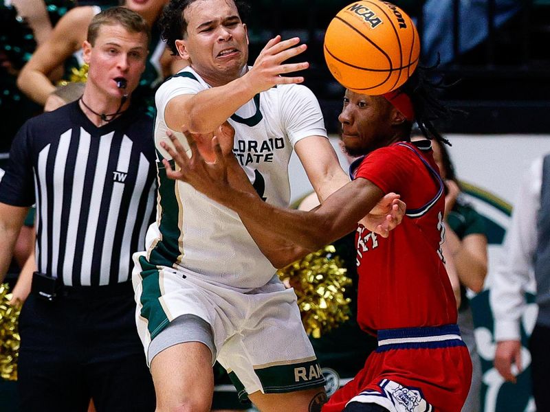 Feb 24, 2026; Fort Collins, Colorado, USA; Colorado State Rams guard Jase Butler (4) and Fresno State Bulldogs forward Deshawn Gory (35) battle for the ball in the second half at Moby Arena. Mandatory Credit: Isaiah J. Downing-Imagn Images