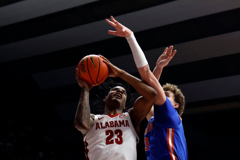 Feb 21, 2024; Tuscaloosa, Alabama, USA; Alabama Crimson Tide forward Nick Pringle (23) is fouled by Florida Gators center Micah Handlogten (3) as he shoots during the first half at Coleman Coliseum. Mandatory Credit: Butch Dill-USA TODAY Sports