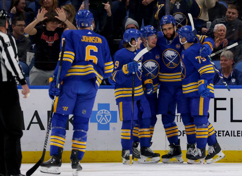 Dec 21, 2023; Buffalo, New York, USA;  Buffalo Sabres left wing Jordan Greenway (12) celebrates his goal with teammates during the first period against the Toronto Maple Leafs at KeyBank Center. Mandatory Credit: Timothy T. Ludwig-USA TODAY Sports