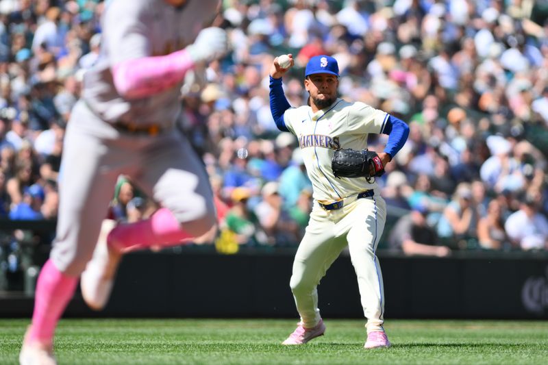 May 12, 2024; Seattle, Washington, USA; Seattle Mariners starting pitcher Luis Castillo (58) throws the ball to first base for a force out on Oakland Athletics third baseman Brett Harris (77) during the fifth inning at T-Mobile Park. Mandatory Credit: Steven Bisig-USA TODAY Sports